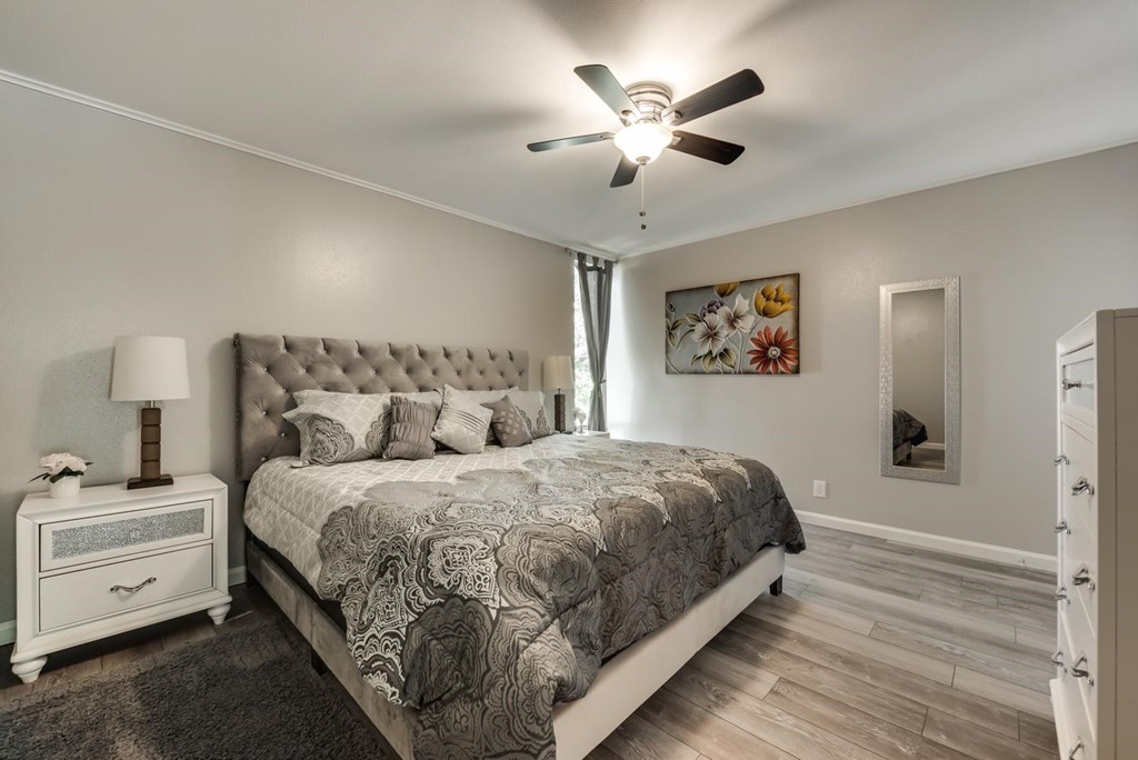 a bedroom with a bed and a ceiling fan