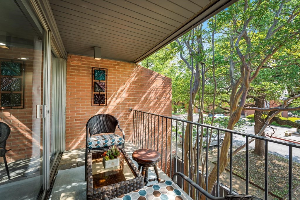 a balcony with a chair and a table on it