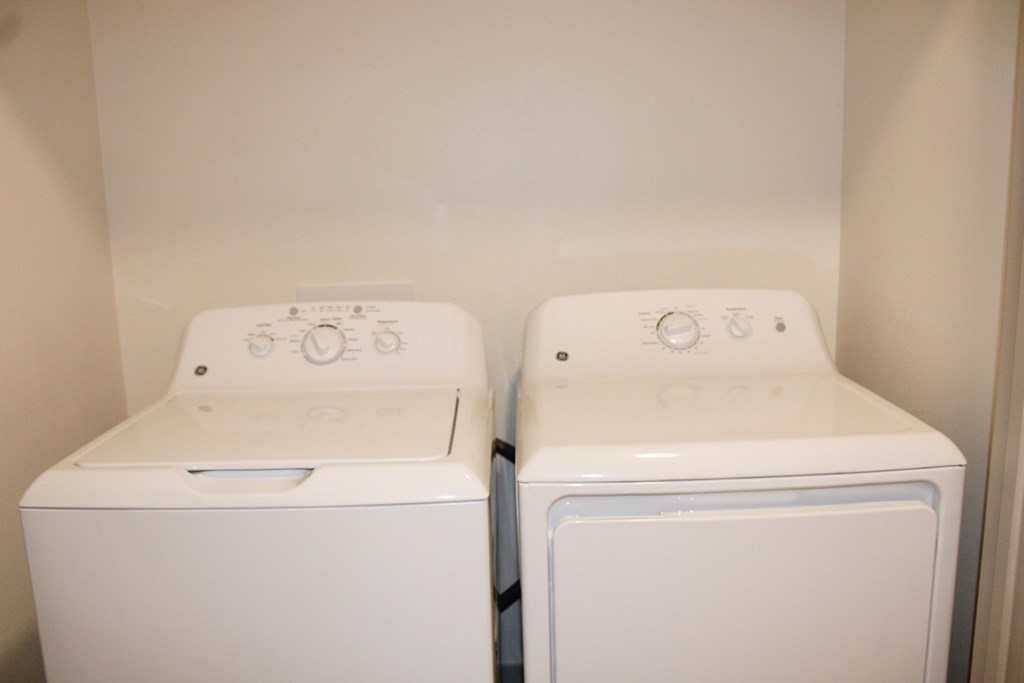 two washers and dryers in the laundry room of a home