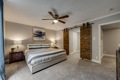 a bedroom with a bed and a ceiling fan