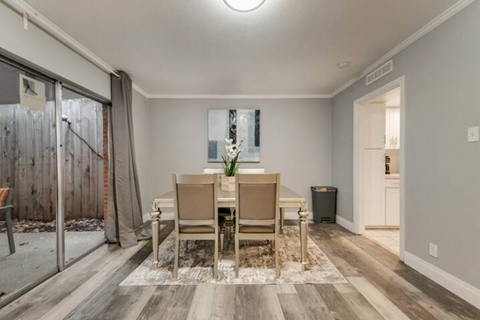 a dining room with a table and chairs