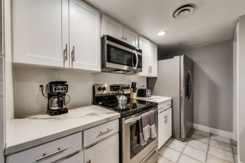a kitchen with a stove microwave and refrigerator