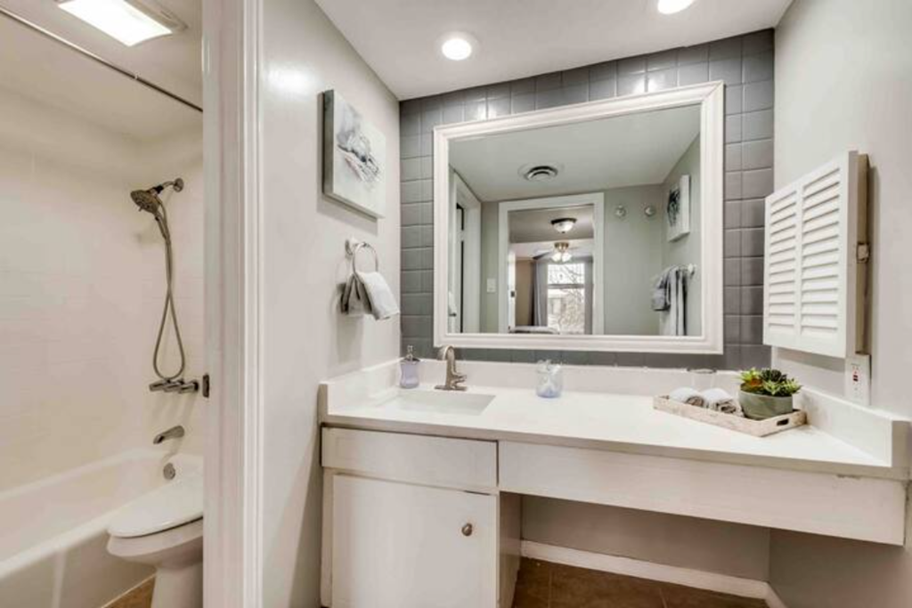 a white bathroom with a sink and a mirror