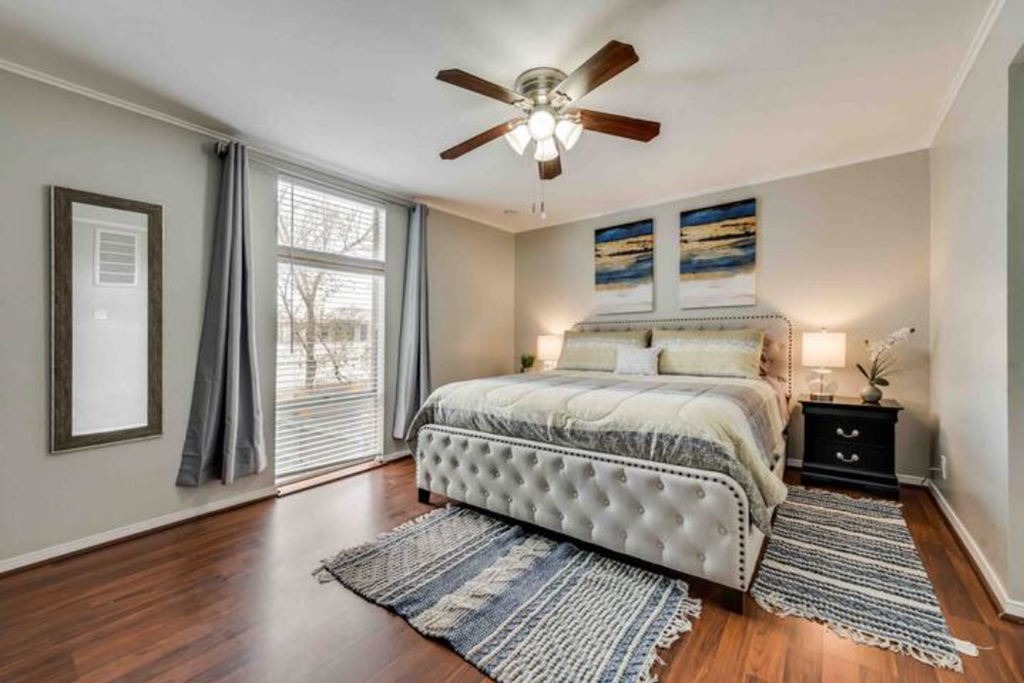 a bedroom with a bed and a ceiling fan