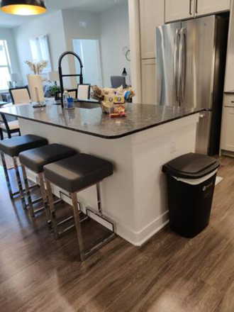 a kitchen with a counter top and some bar stools