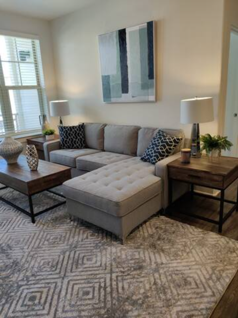 a living room with a couch and two tables