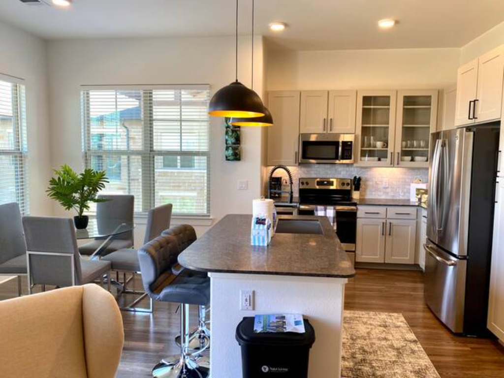 a kitchen and dining room with a table and chairs
