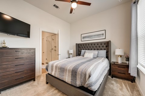 a bedroom with a bed and a tv