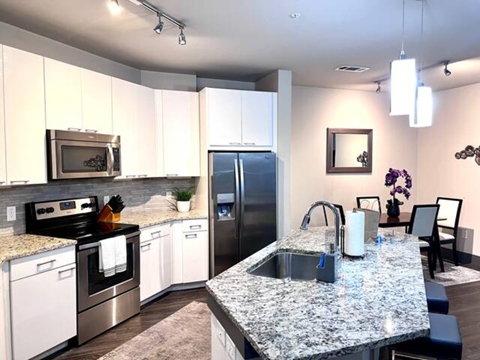 a kitchen with stainless steel appliances and granite counter tops