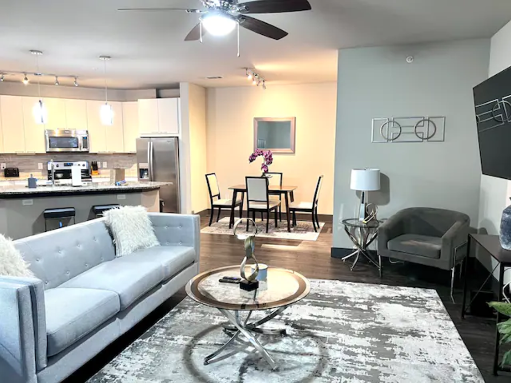 an open living room and kitchen with a couch and a table