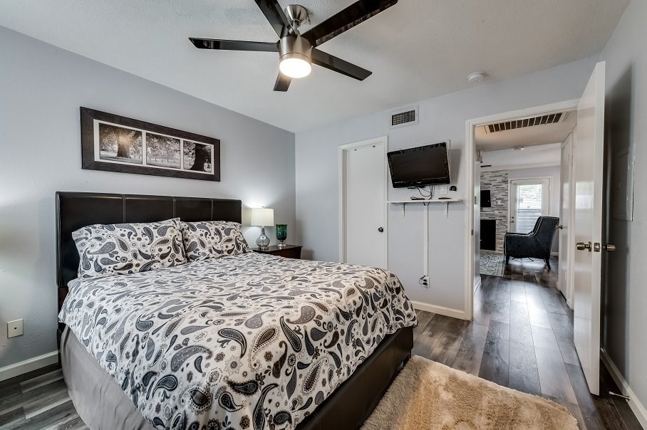 a bedroom with a bed and a ceiling fan