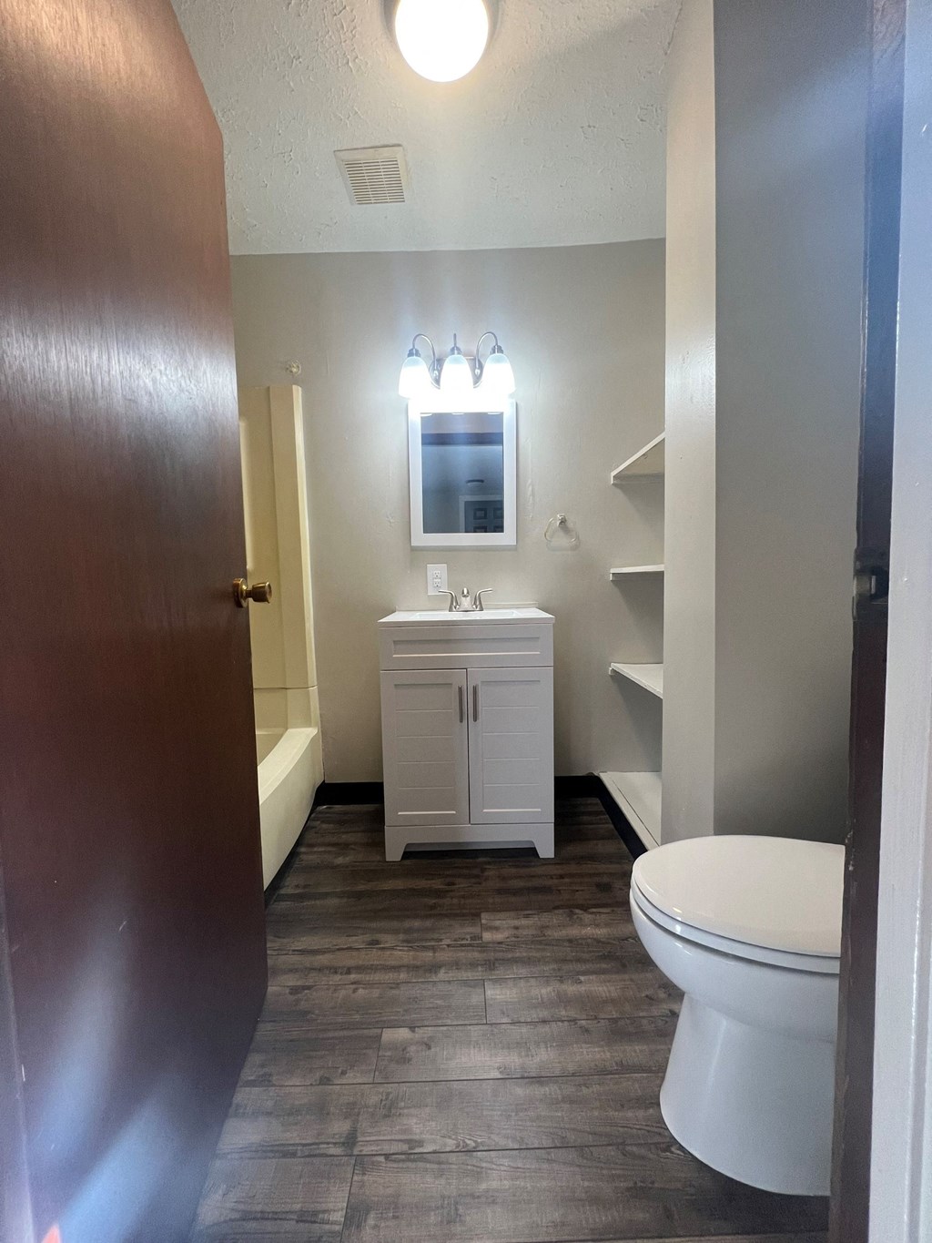 a bathroom with a toilet and a sink and a mirror