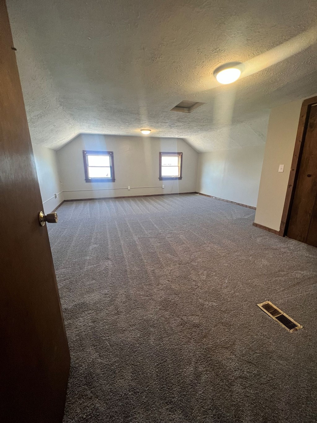 an empty room with a door and a window