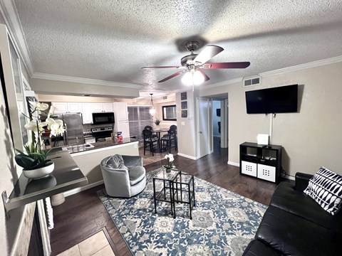 the view of the living room and kitchen from the front door
