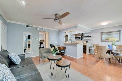a living room and kitchen with a couch and a table
