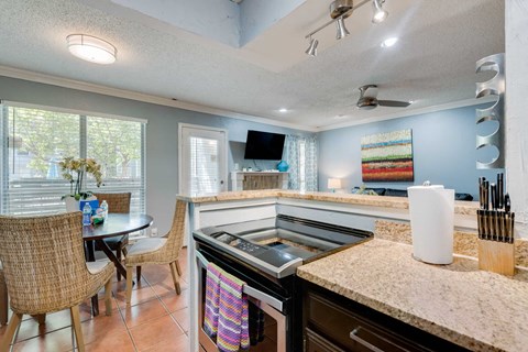 a kitchen with a stove and a table with chairs