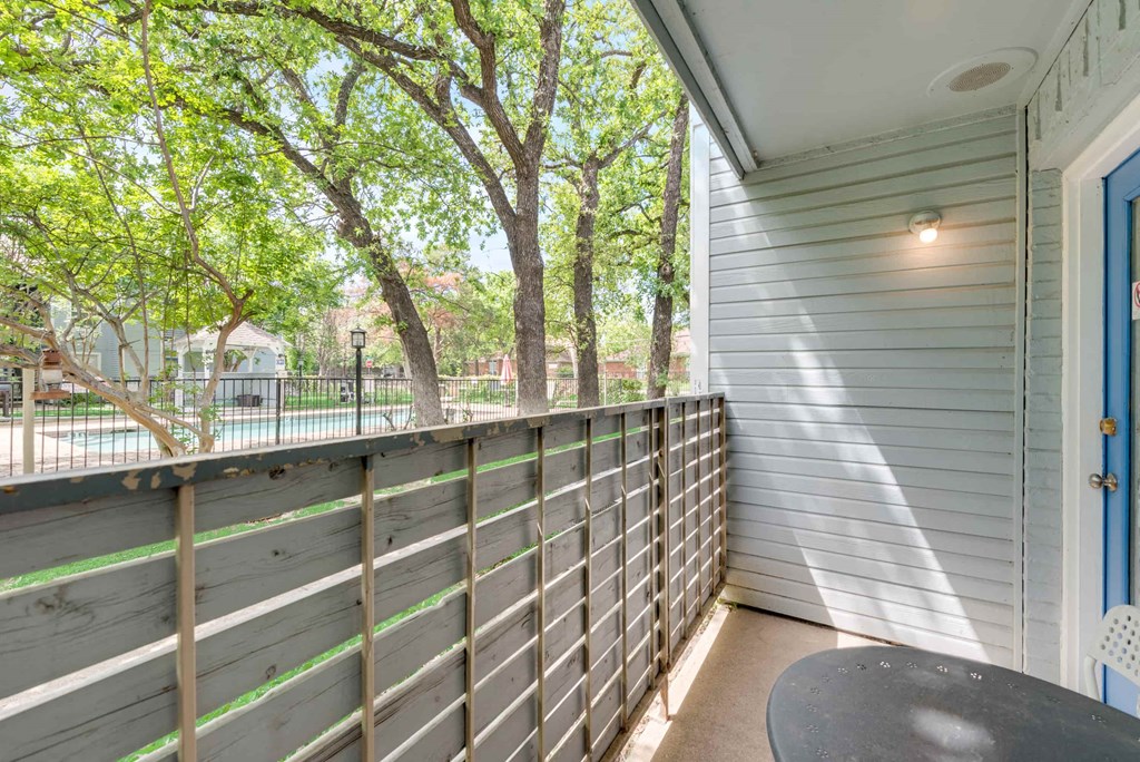 a patio with a table and a blue door