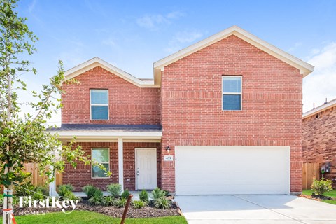 a red brick house with a white garage door