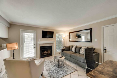 a living room with a couch and a fireplace