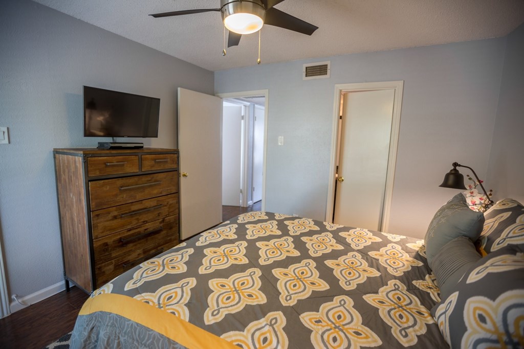 another bedroom with a large bed and a tv