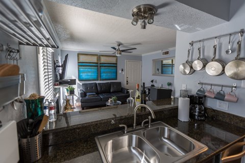 a view of the kitchen and living room from behind the sink