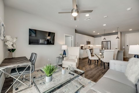 a living room and dining room with a table and chairs