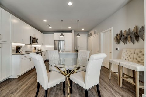 a kitchen and dining room with a glass table