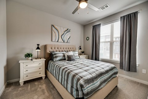 a bedroom with a bed and a ceiling fan