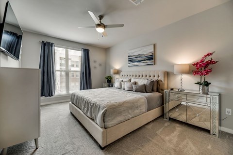 a bedroom with a bed and a ceiling fan