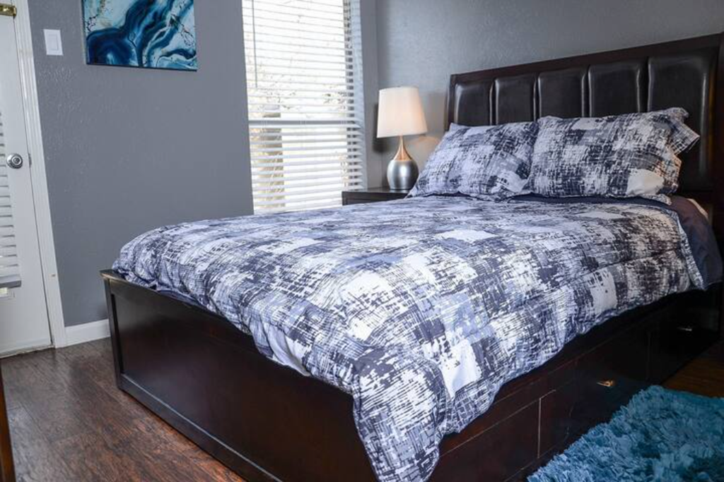 a bedroom with a bed with a blanket on it