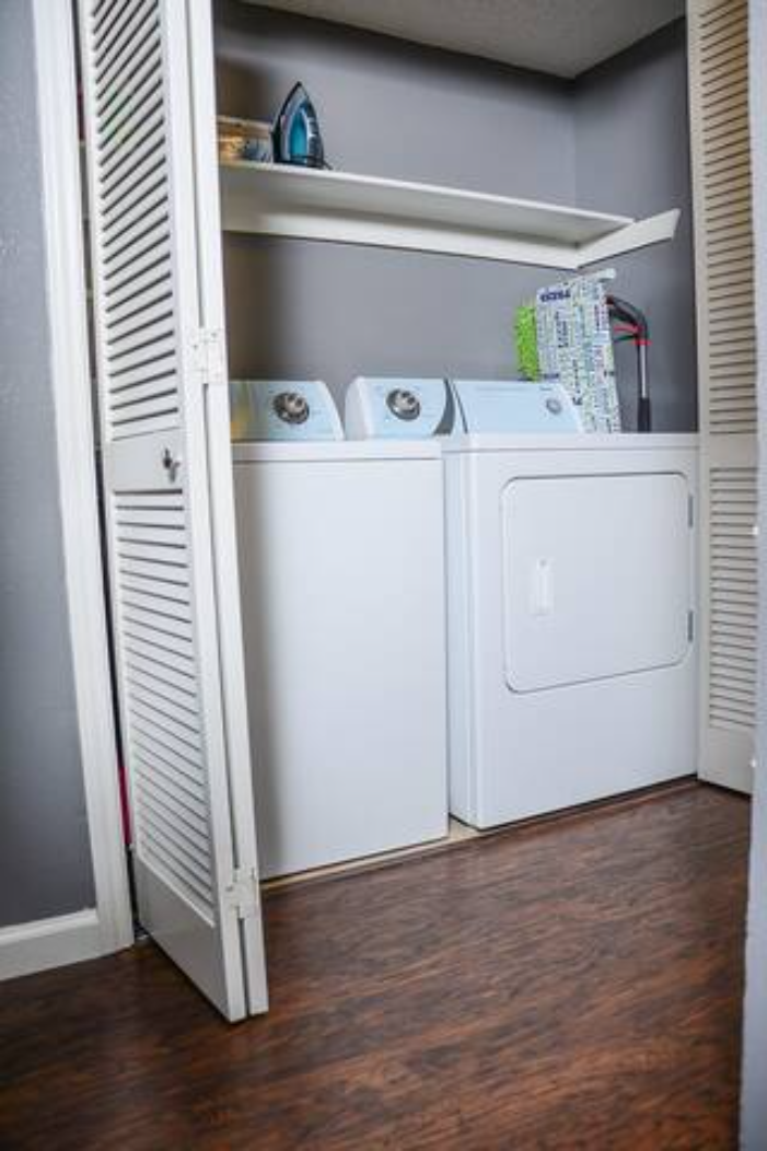 a white washer and dryer in a room with a closet