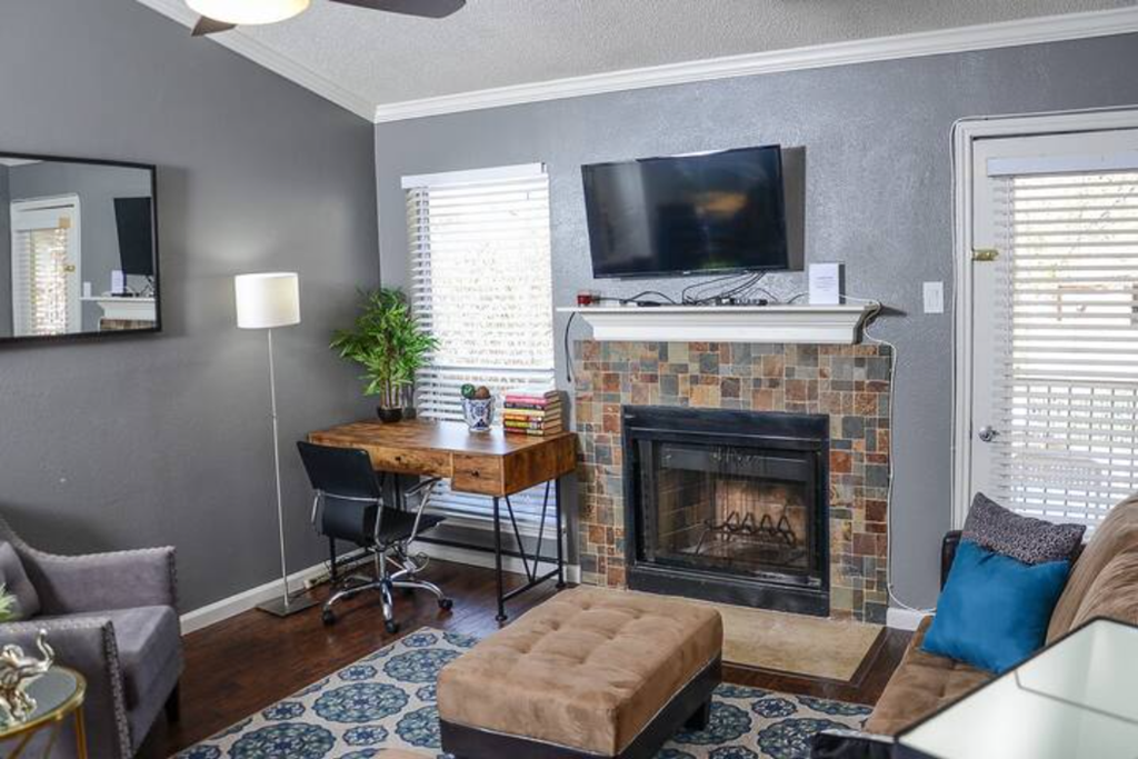 a living room with a fireplace and a television