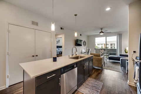 a kitchen with an island and a living room with a couch