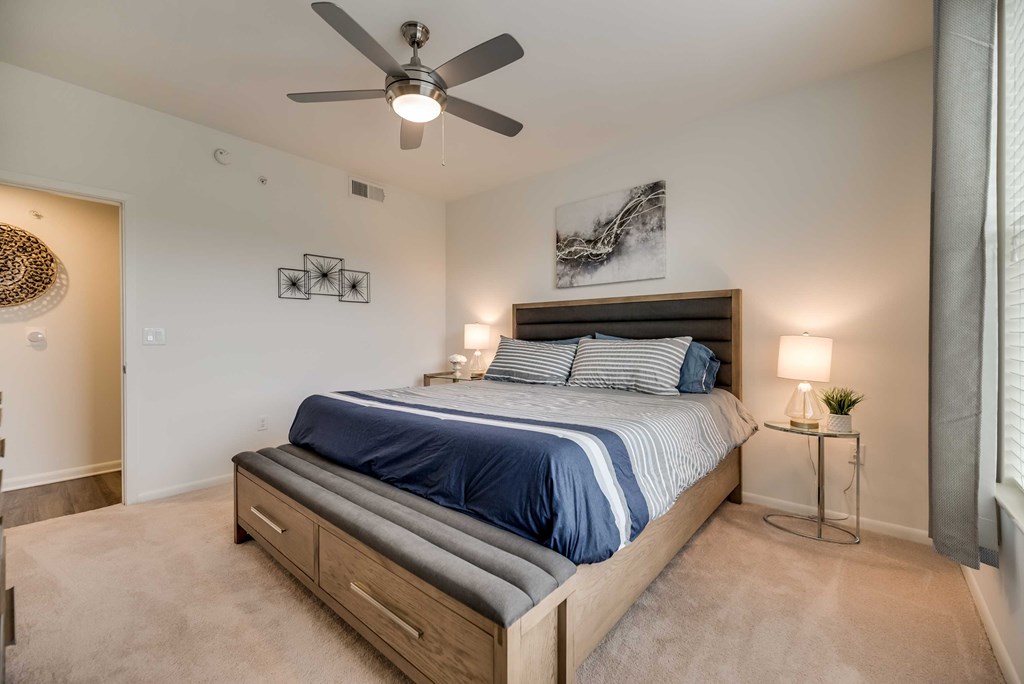 a bedroom with a bed and a ceiling fan