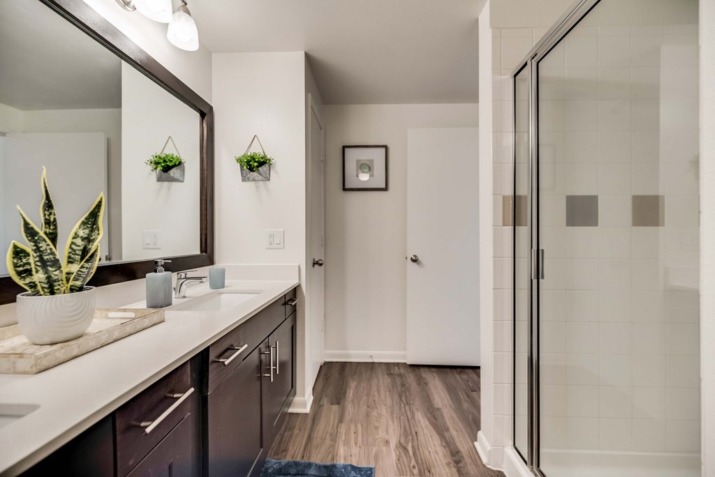a bathroom with a large mirror and a shower