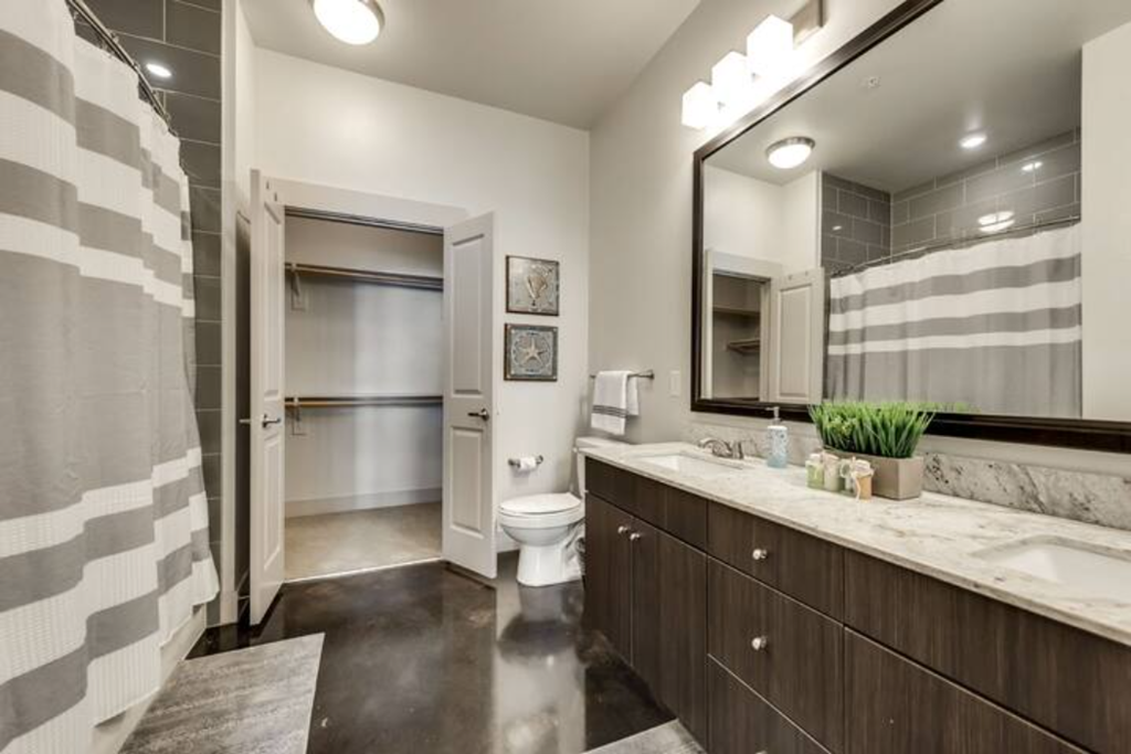 a bathroom with a sink and a toilet and a shower