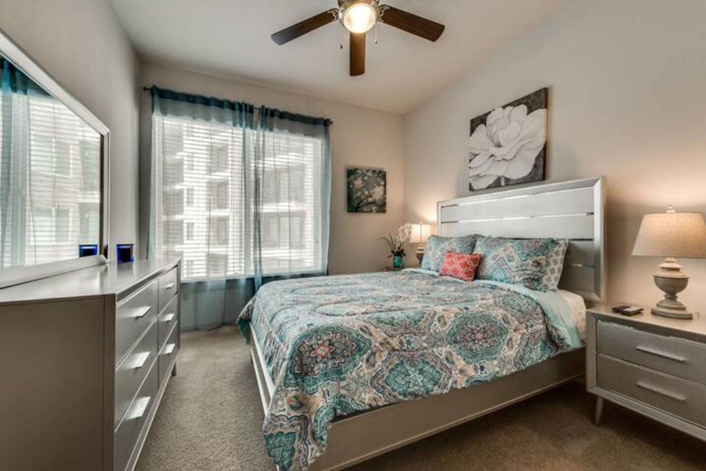 a bedroom with a bed and a ceiling fan