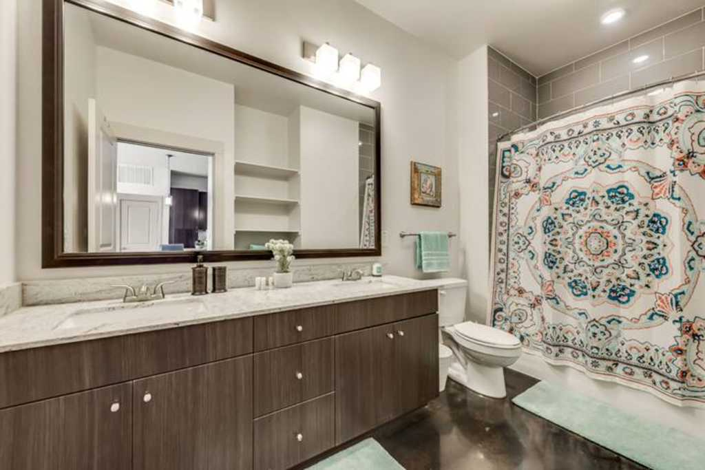 a bathroom with a toilet and a sink and a mirror