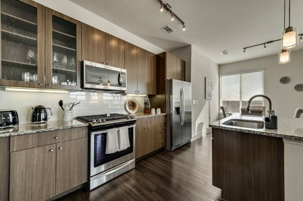 a kitchen with stainless steel appliances and wooden cabinets