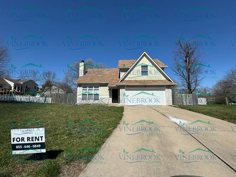 a house with a for rent sign in front of it