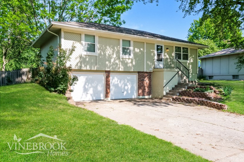 a suburban house with a driveway and a garage door