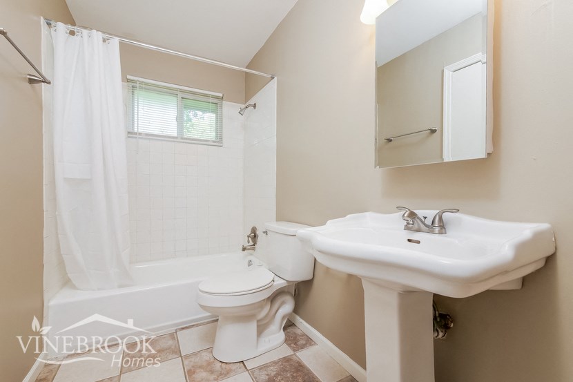 a bathroom with a sink toilet and a tub
