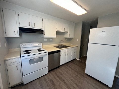 a kitchen with white appliances and white cabinets