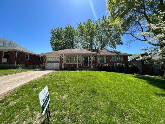 A house with a sign in front of it that says "FOR SALE".