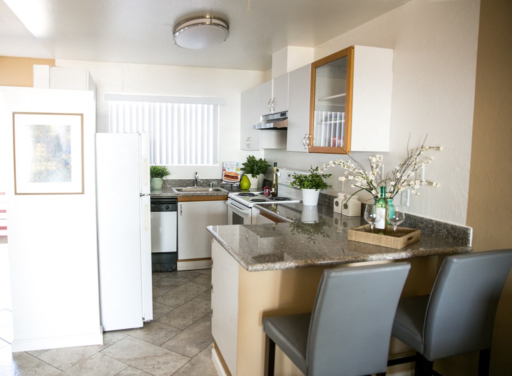 a kitchen with a granite counter top and a dining area