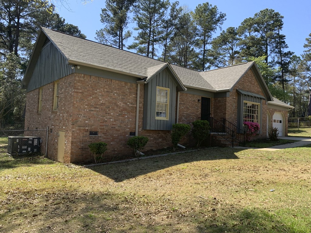a brick house with a lawn in front of it
