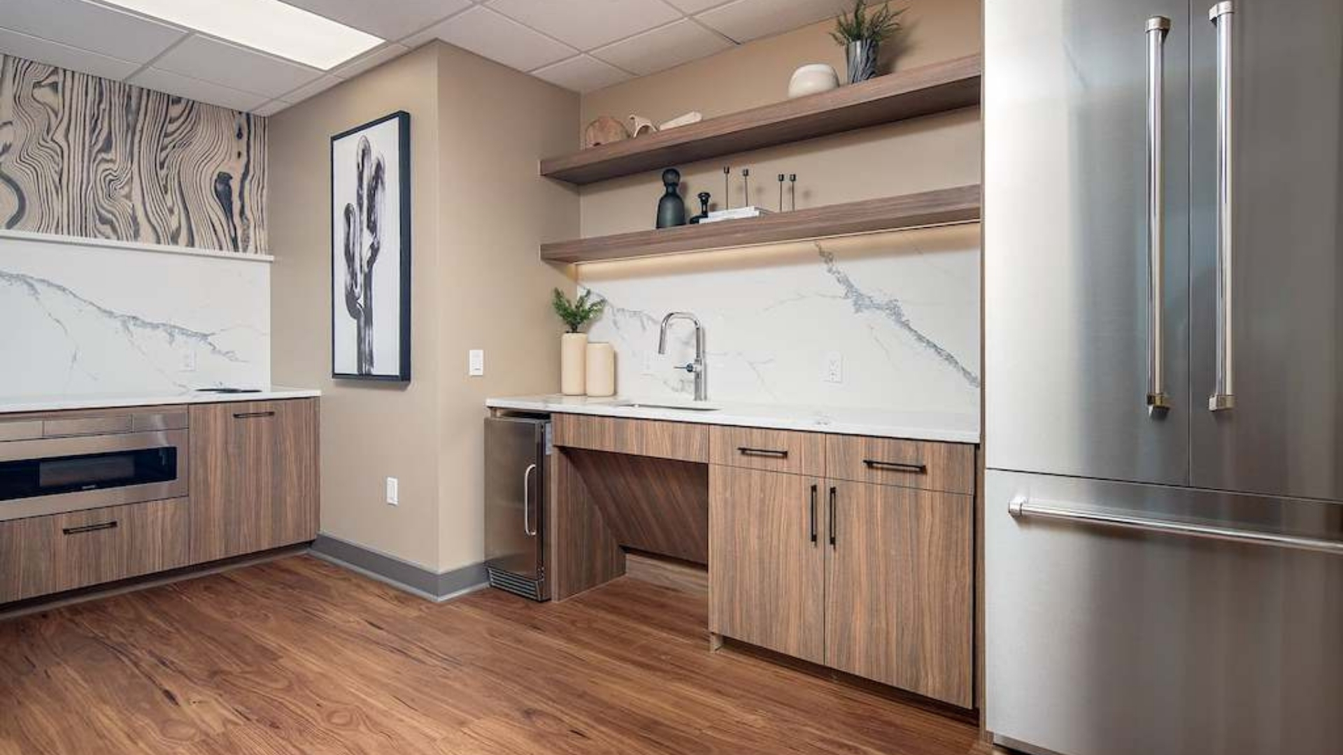 A kitchen with wooden floors and a marble countertop.
