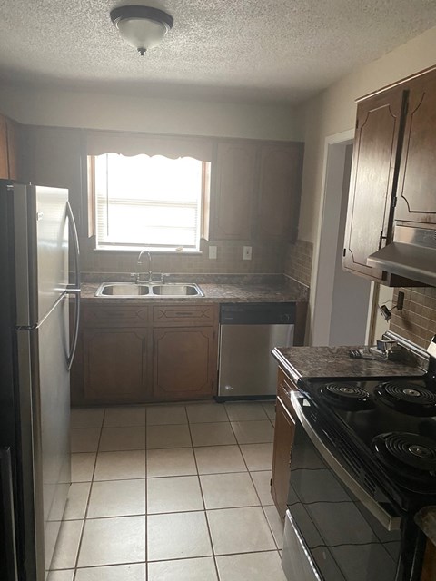 a kitchen with a sink and a refrigerator