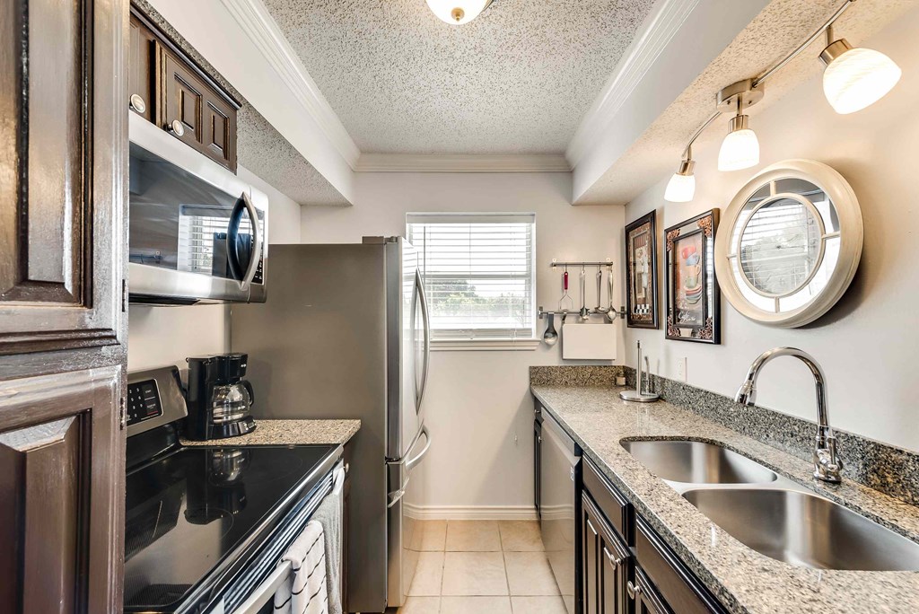 full kitchen with stainless steel appliances and granite counter tops