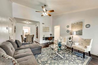 a living room with couches and a glass coffee table